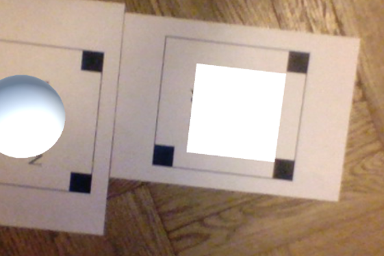Fig. 2. Working multi marker AR system with a sphere and a cube as placeholders.