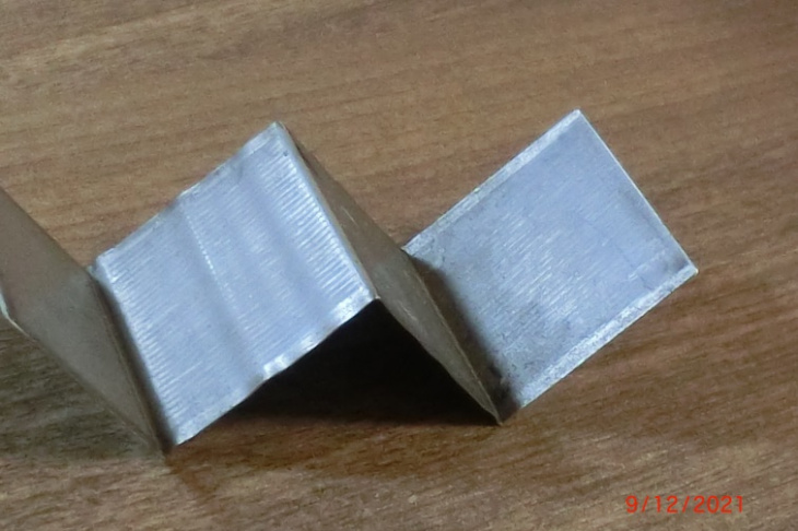 Fig. 9. Corrugations formation as a result of plastic deformation during the reshaping of W-shaped blanks in a tool die